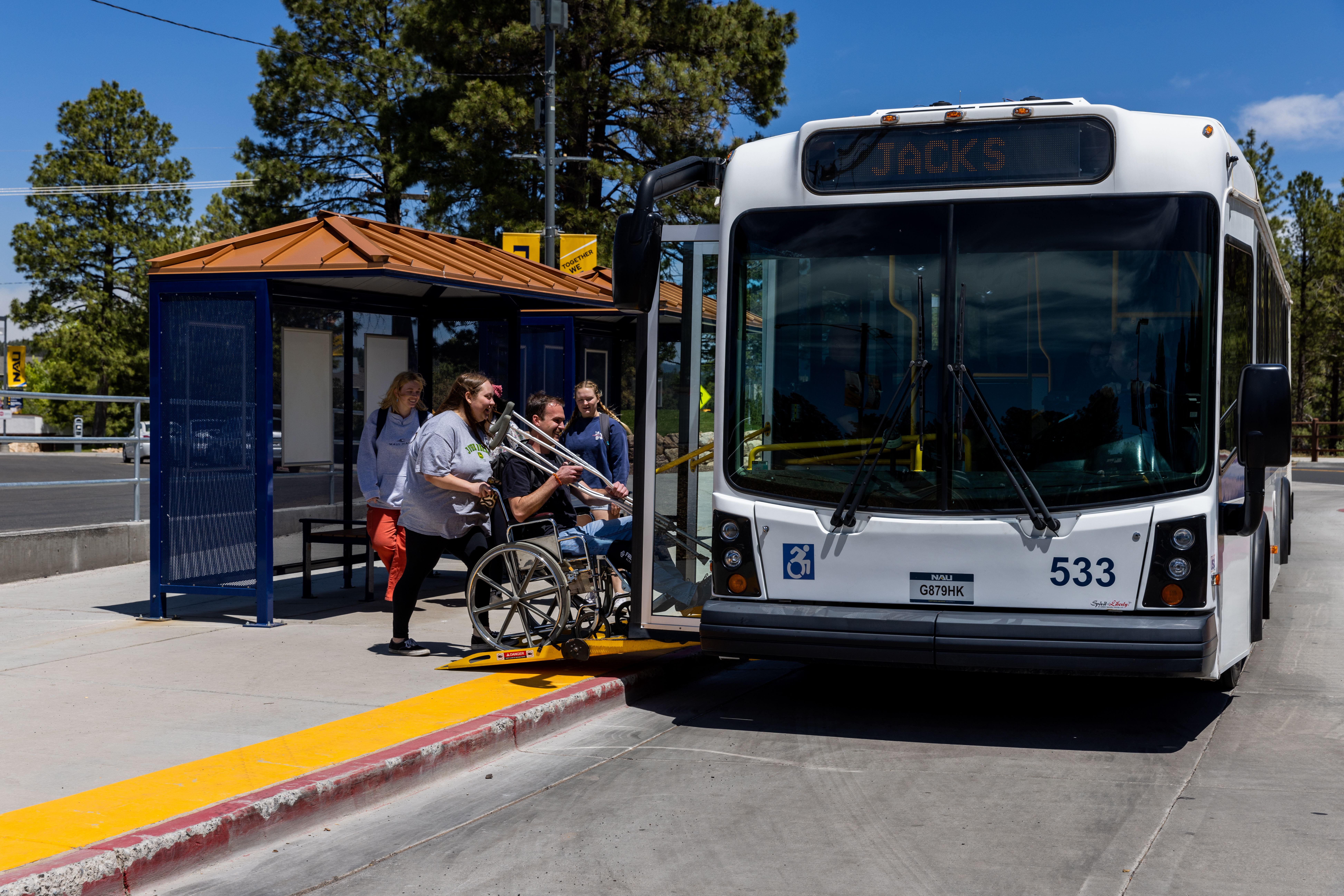 NAU Shuttle picks up students at the bus stop.