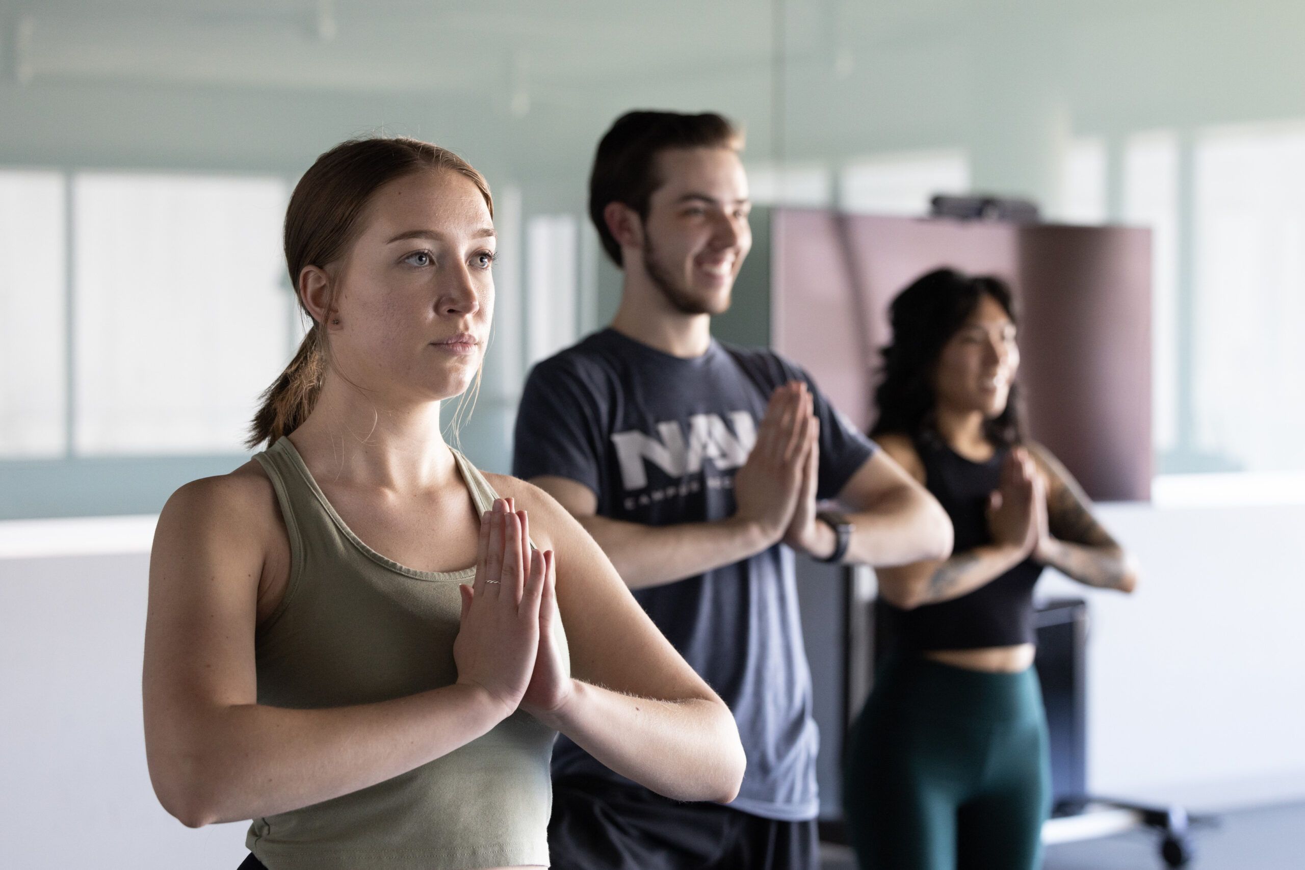 Students doing the prayer hands yoga pose.