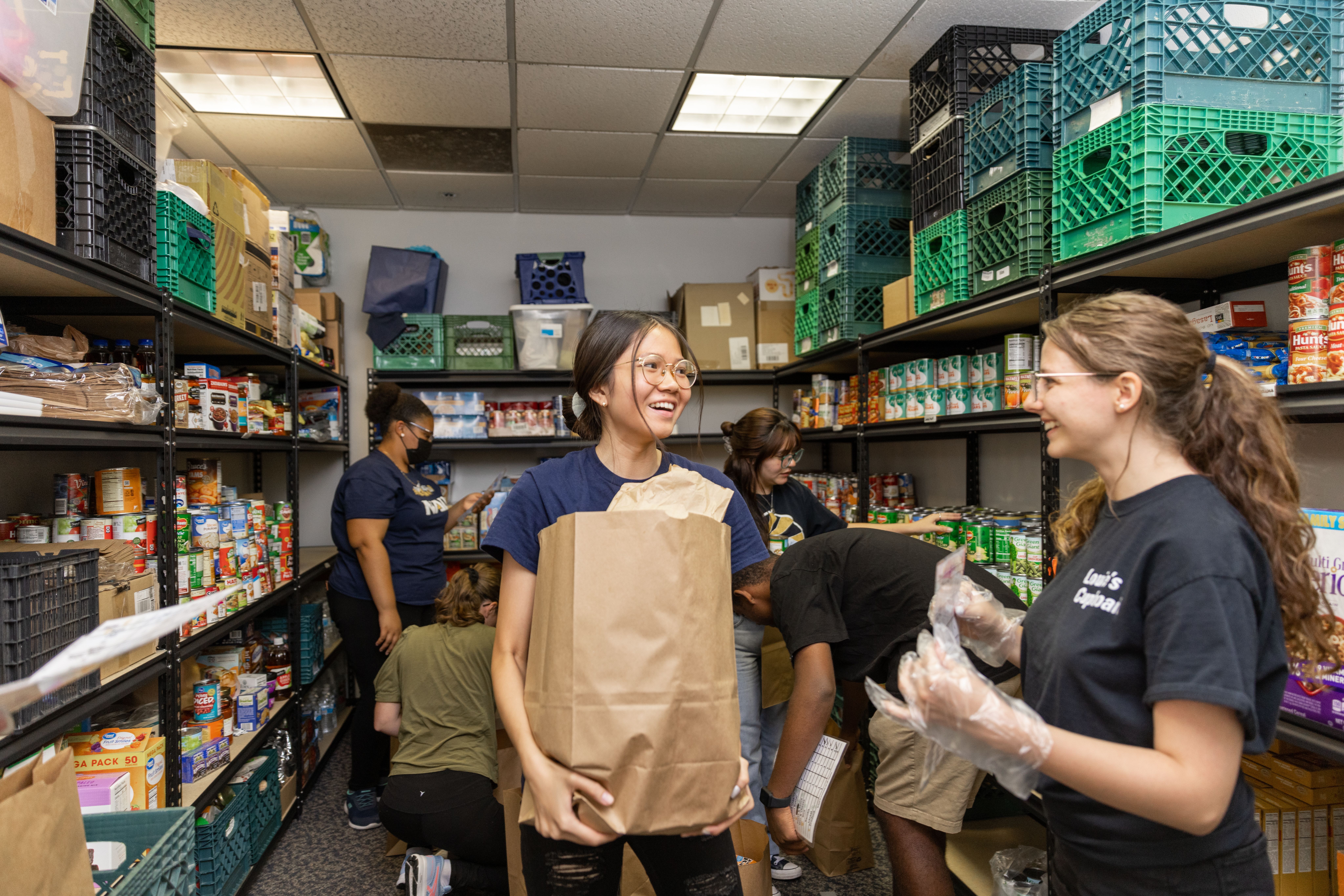 Students pick up groceries from a Louie's Cupboard food distribution event.
